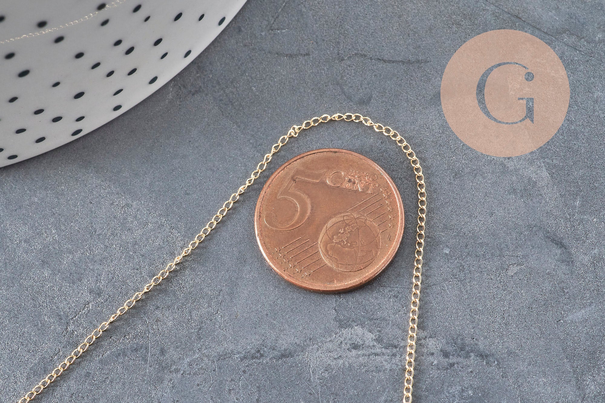Chaîne fine gold-filled 14K de 45.7cm avec fermoir doré, posée à côté d'une pièce de 5 centimes.