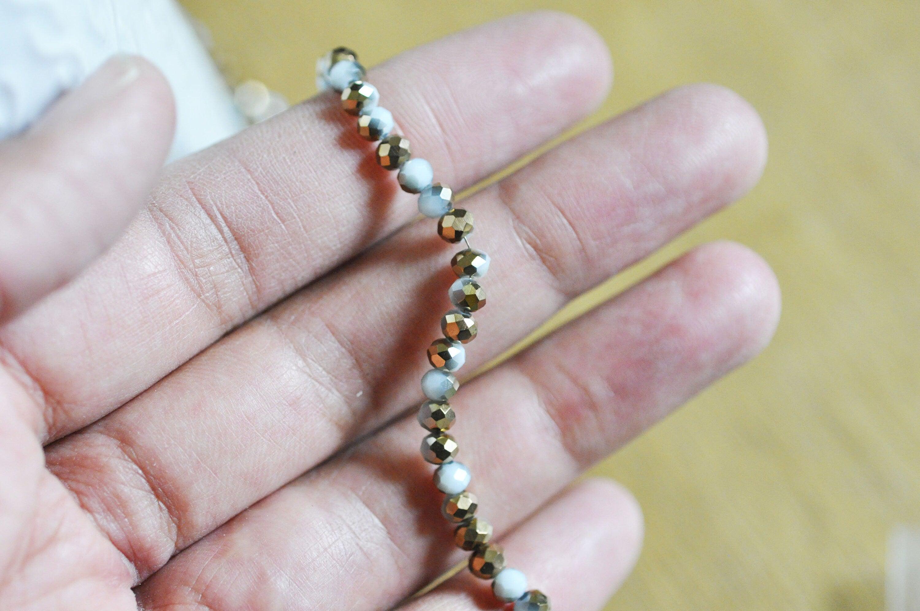 EP Perles toupies cristal blanc doré 4x3mm, x1 fil de 120