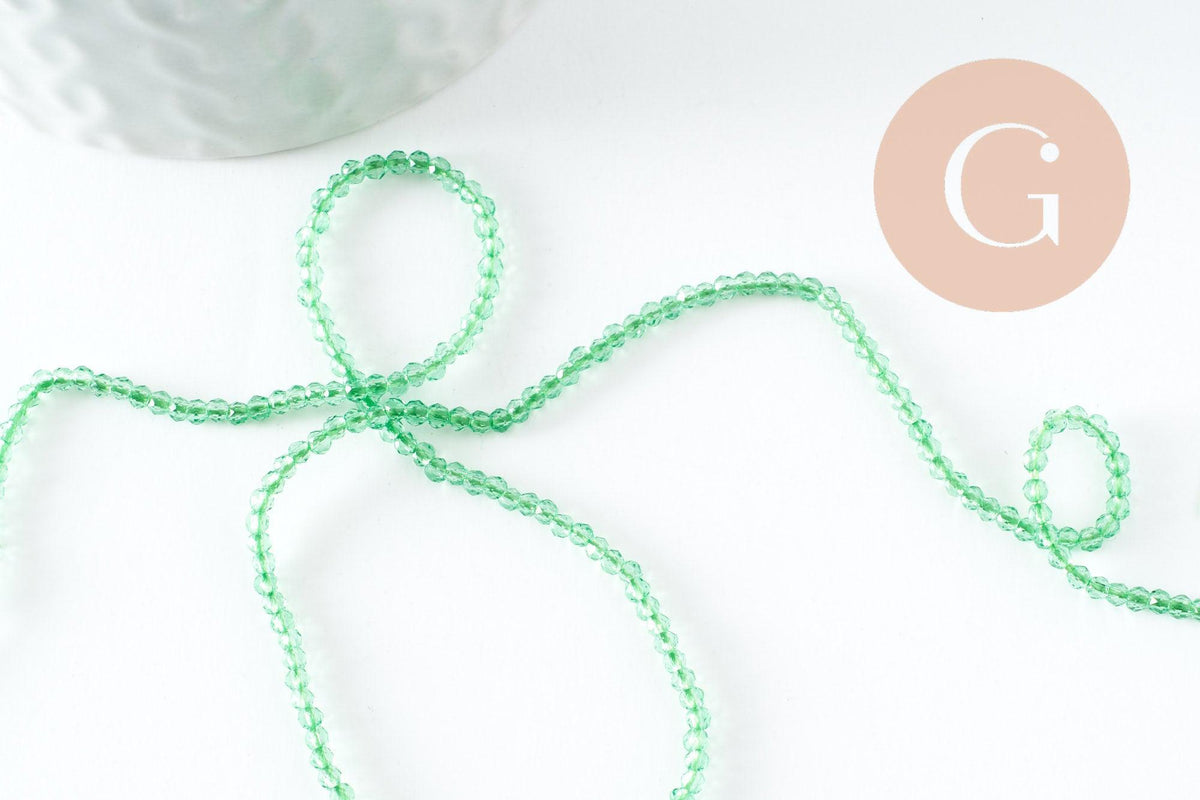 Perle ronde verre facettée transparente vert clair 2mm, x1 fil de 37cm (G7445)