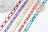 Ruban texte BISOUS 10mm, un ruban brodé de qualité pour travaux de couture ou création de bijoux, x1 mètre (G10830)