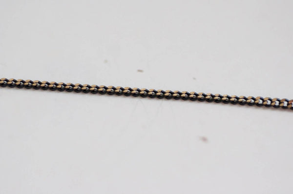 EP-Chaine fine maille plate noire reflets dorés 1.5mm, X 5 mètres G0554