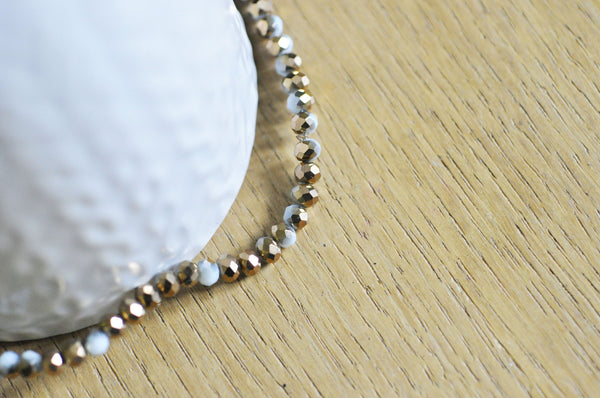 EP Perles toupies cristal blanc doré 4x3mm, x1 fil de 120