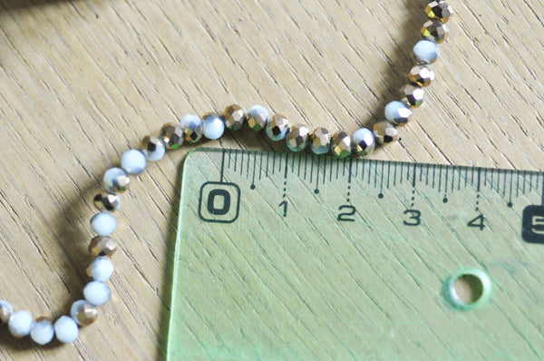 EP Perles toupies cristal blanc doré 4x3mm, x1 fil de 120