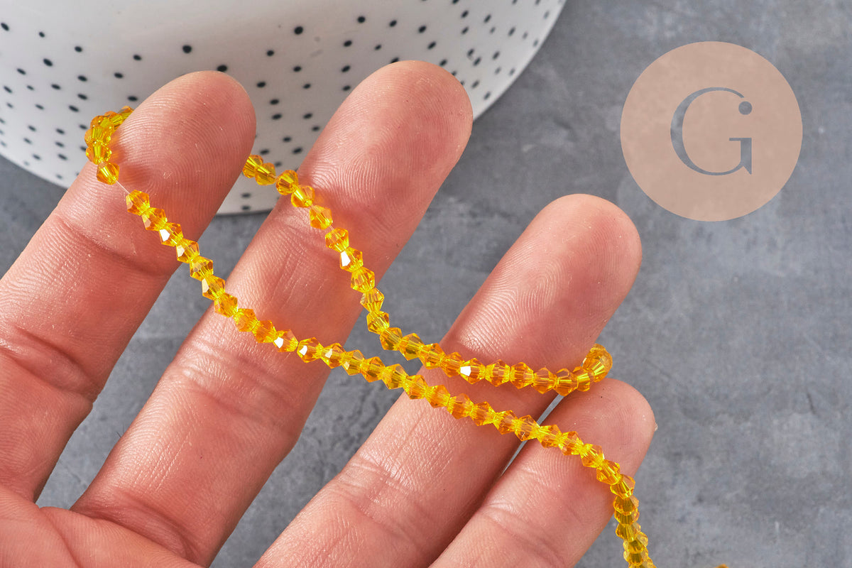 Cuentas toupie de cristal facetado amarillo 3.8x3mm, x1 hilo de 32.5cm (G11343)