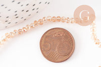Perles toupies cristal orange transparent irisé 3.5x2.5mm, x1 fil 25cm (G8595)